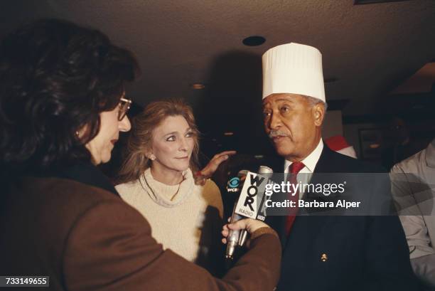 American singer-songwriter Judy Collins and former Mayor of New York, David Dinkins, are interviewed by a radio reporter at a charitable event in New...
