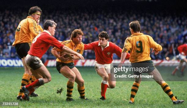 Simon Poidevin of the Wallabies is tackled during a Rugby Union test match between Wales and the Australian Wallabies at the Millennium Stadium in...