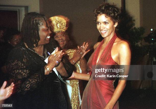 Actress/model Halle Berry is applauded as she receives an award from Dorothy Height of the National Council of Negro Women during a dinner in...