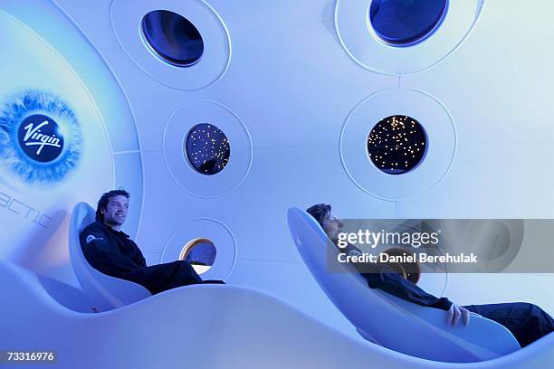 Virgin employees sit in the cabin of a prototype Virgin Galactic SpaceShipTwo spacecraft at the Science Museum on February 14, 2007 in London,...