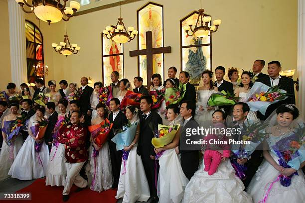 Couples attend a celebration to mark Valentines Day in a church on February 14, 2007 in Xian of Shaanxi Province, China. As the festival draws near,...