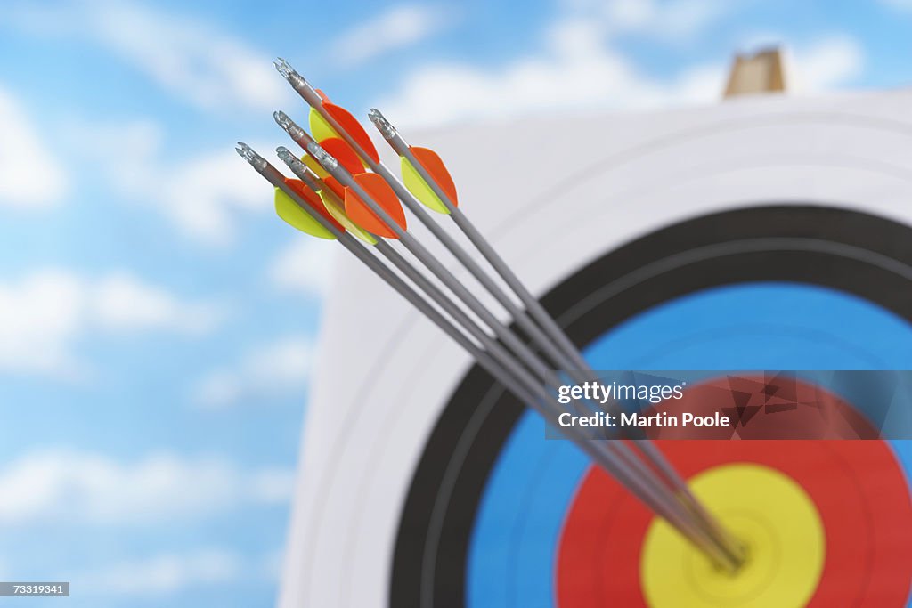 Arrows in bullseye of target, focus on arrows, close up