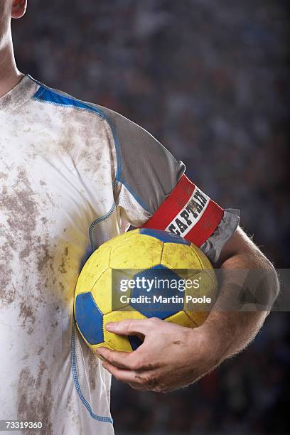 soccer captain holding ball underarm, close up of ball - embrace imagens e fotografias de stock