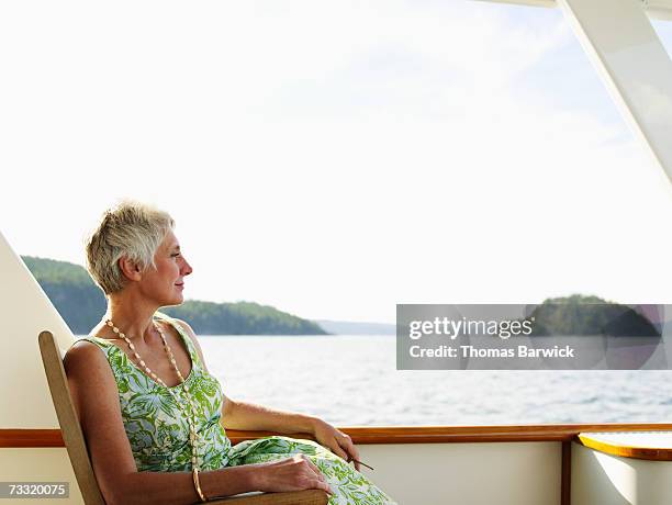 senior woman relaxing on deck of yacht - wonderlust2015 stock pictures, royalty-free photos & images