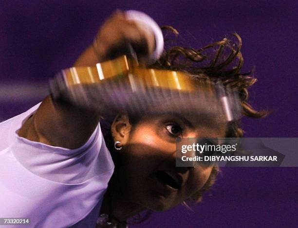 Indian tennis player Sania Mirza serves against her Slovakian opponent Martina Sucha during the first round match of the WTA Bangalore Open in...