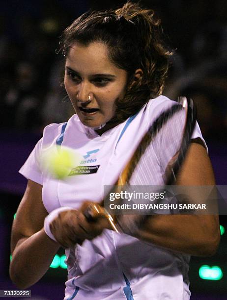 Indian tennis player Sania Mirza plays a shot against her Slovakian opponent Martina Sucha during the first round match of the WTA Bangalore Open in...