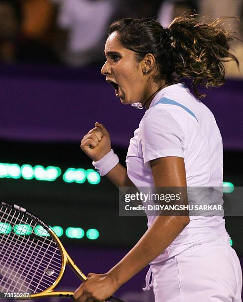 Indian tennis player Sania Mirza celebrates a point against her Slovakian opponent Martina Sucha during the first round match of the WTA Bangalore...
