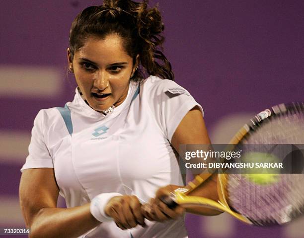 Indian tennis player Sania Mirza plays a shot against her Slovakian opponent Martina Sucha during the first round match of the WTA Bangalore Open in...