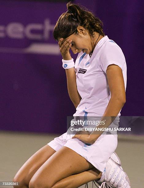 Indian tennis player Sania Mirza reacts after a line call in favour of her Slovakian opponent Martina Sucha during the first round match of the WTA...