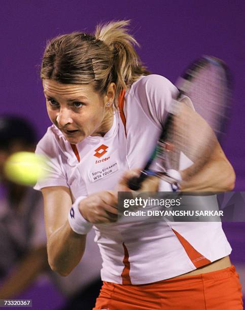 Slovakian tennis player Martina Sucha plays a shot against her Indian opponent Sania Mirza during the first round match of the WTA Bangalore Open in...