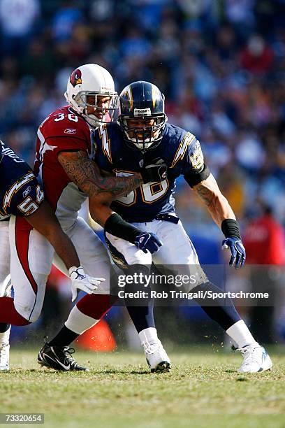 Linebacker Shawne Merriman of the San Diego Chargers rushes the passer as Obafemi Ayanbadejo of the Arizona Cardinals blocks at Qualcomm Stadium on...