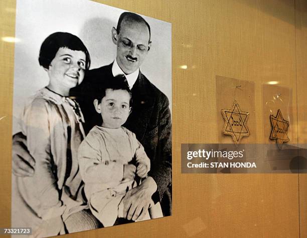 New York, UNITED STATES: A photograph of Otto Frank with his daughters Anne and Margaret with yellow stars worn by Dutch Jews is shown over a display...