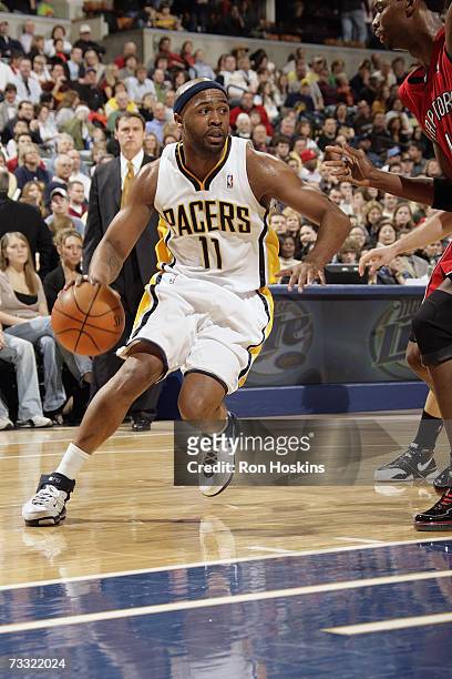 Jamaal Tinsley of the Indiana Pacers dribble drives to the basket against the Toronto Raptors during the game at Conseco Fieldhouse on January 27,...