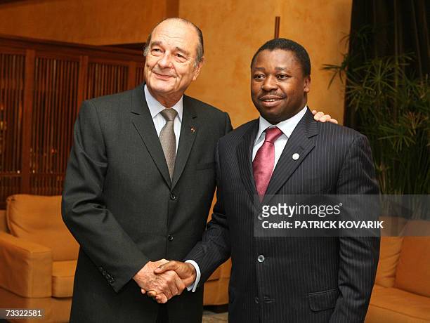 French President Jacques Chirac shakes hands with Togolese counterpart Faure Gnassingbe before a diner, 14 February 2007 in Cannes, southern France,...
