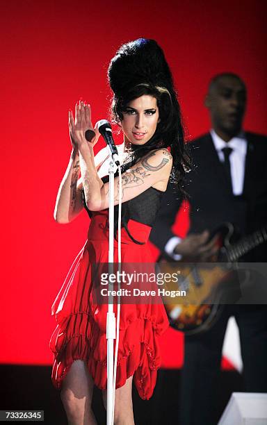 Singer Amy Winehouse performs on stage at The BRIT Awards 2007 in association with MasterCard at Earls Court 1 on February 14, 2007 in London,...