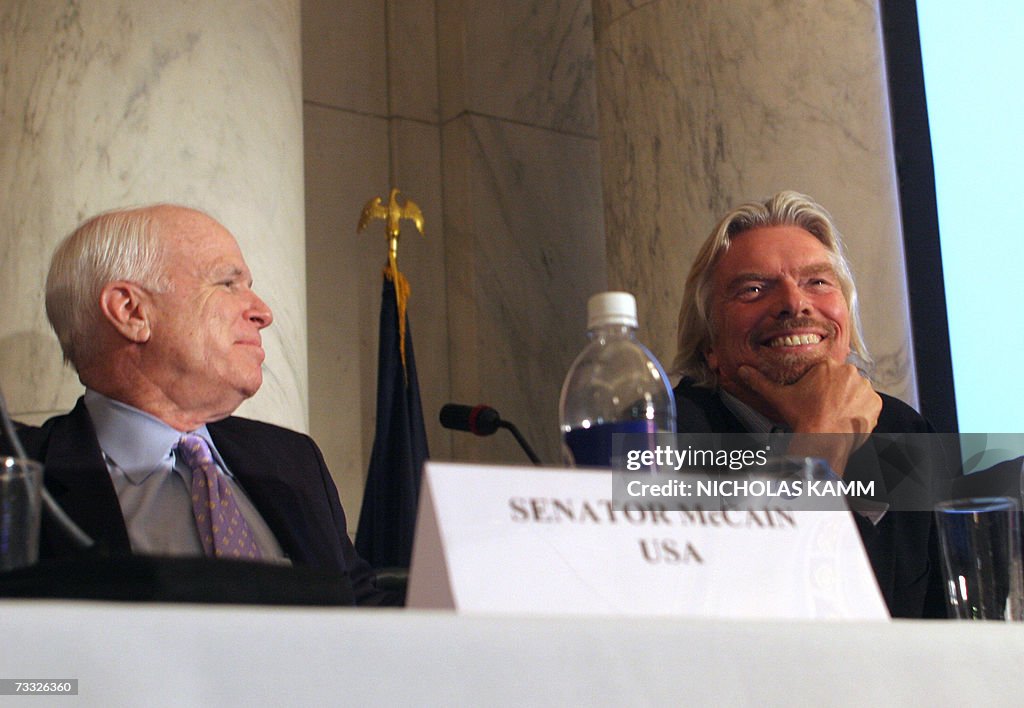 Virgin founder Sir Richard Branson (R) a...