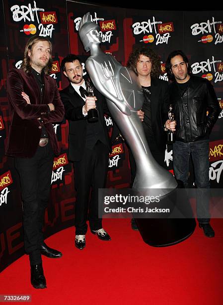 Mark Stoermer, Brandon Flowers, David Keuning and Ronnie Vannucci of Killers pose in the awards room after winning the awards for best International...