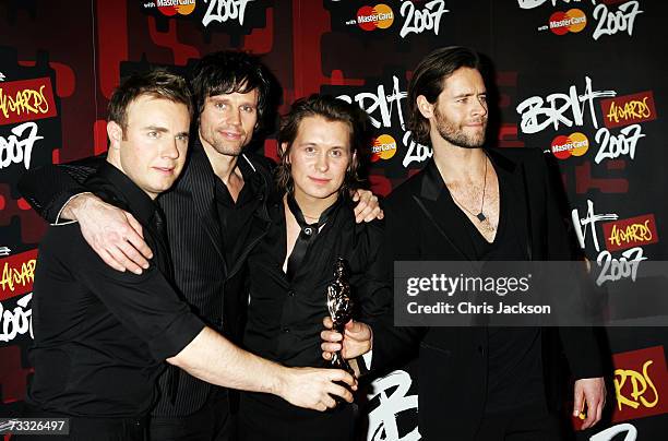 Gary Barlow, Jason Orange, Mark Owen and Howard Donald of Take That pose in the awards room after winning the award for best British Single at the...