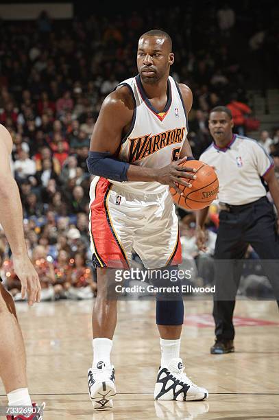 Baron Davis of the Golden State Warriors holds the ball against the New Jersey Nets on January 24, 2007 at Oracle Arena in Oakland, California. The...