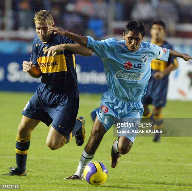 Martin Palermo from Boca Juniors vies for the ball with Leonel Reyes from Bolivar during their Libertadores Cup football match played 14 February,...