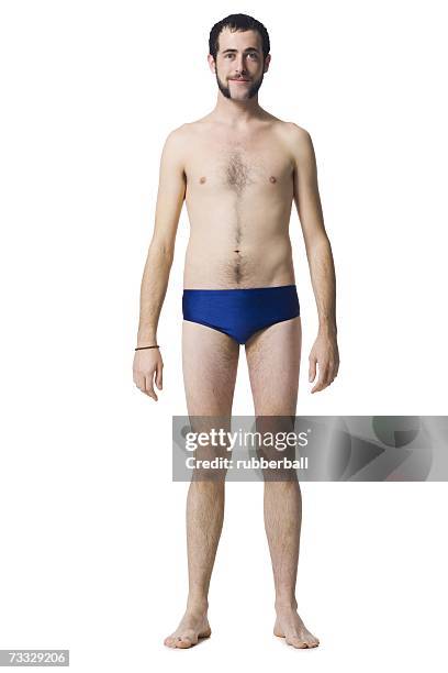 man standing in swimsuit smiling - young men in speedos 個照片及圖片檔