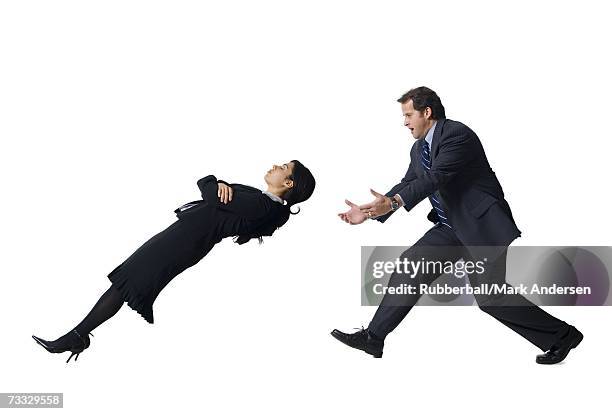 businessman catching falling businesswoman - bending over backwards stock pictures, royalty-free photos & images