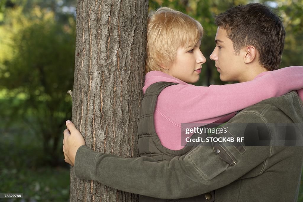 Teenage couple near a tree, selective focus