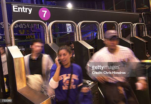 Mets and Yankees fans flood into Shea Stadium for Game 3 of the World Series October 24, 2000 in New York.