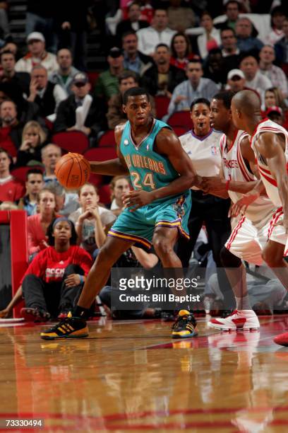 Desmond Mason of the New Orleans/Oklahoma City Hornets is defended by Tracy McGrady of the Houston Rockets during the game at the Toyota Center on...