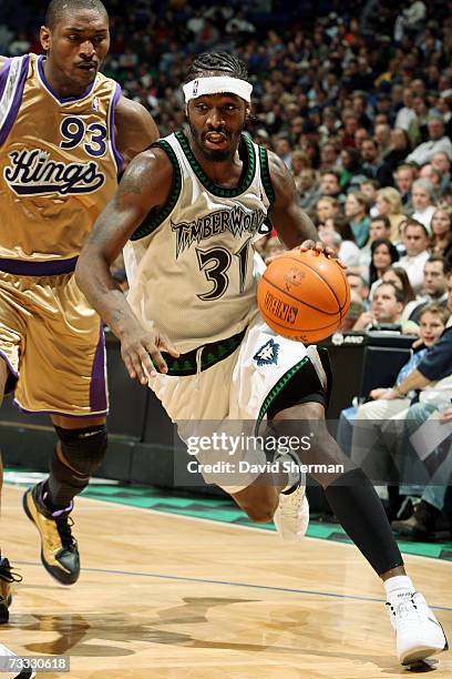 Ricky Davis of the Minnesota Timberwolves drives to the basket against Ron Artest of the Sacramento Kings during the game at Target Center on January...