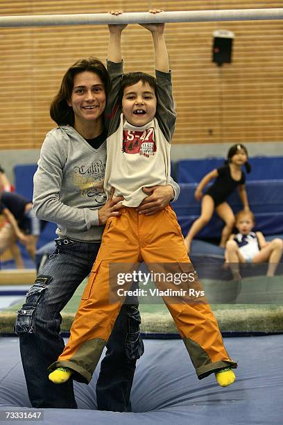 German gymnast Oksana Chusovitina pose for a photo with her son Alisher prior to the training on December 04, 2006 in Cologne, Germany.