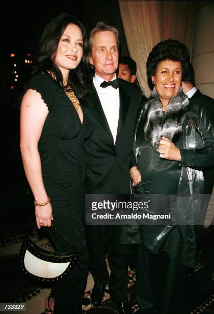 Carla Fendi, president of Fendi, stands with actress Catherine Zeta Jones, left, and Jones'' husband/actor Michael Douglas, as they pose for the...