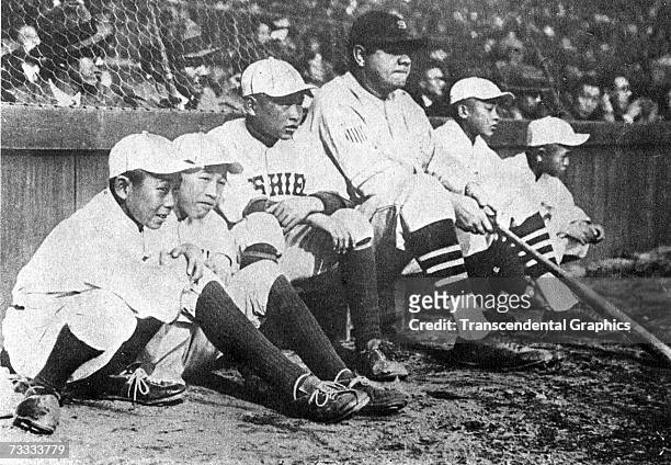 During the 1934 tour of Japan, Babe Ruth poses for a photo with young Japanese players.