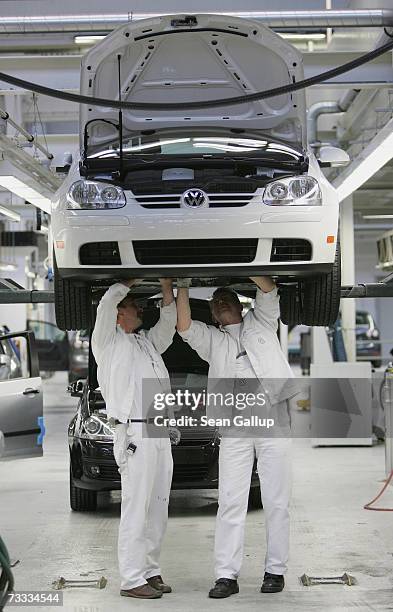 Workers assemble Golf cars at the production line at the Volkswagen factory February 15, 2007 in Wolfsburg, Germany. Volkswagen's two biggest...