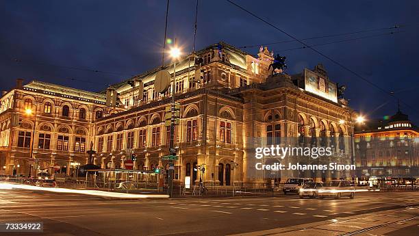 Cars pass the illuminated Vienna Opera house, on February 15 Vienna, Austria. The Vienna Opera Ball will take place there this evening.
