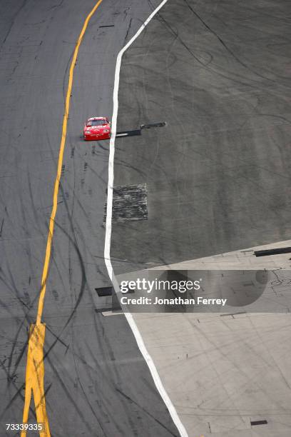 Dale Earnhardt Jr., driver of the Budweiser Chevrolet, drives towards pit road with a flat tire, during the Gatorade Duel at Daytona International...