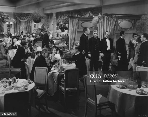 Standing, from centre, left to right: Conrad Veidt , Marius Goring and Howard Marion-Crawford in a scene from 'The Spy In Black' , directed by...
