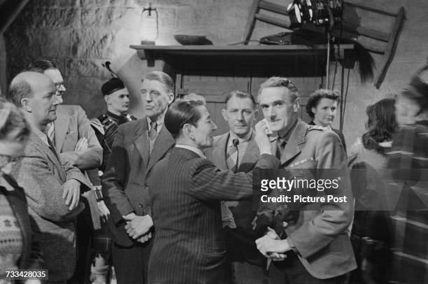 Scottish actor John Laurie has his make-up retouched on the set of 'I Know Where I'm Going!', directed by Michael Powell and Emeric Pressburger,...