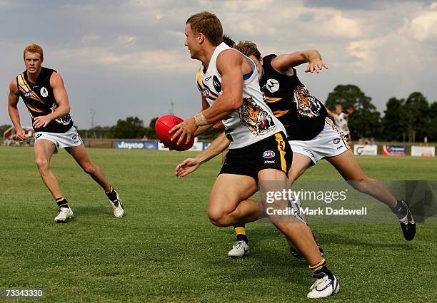 Nathan Brown of Team King evades a tackle during the Richmond Tigers intra-club AFL match at Casey Fields on February 16, 2007 in Melbourne,...