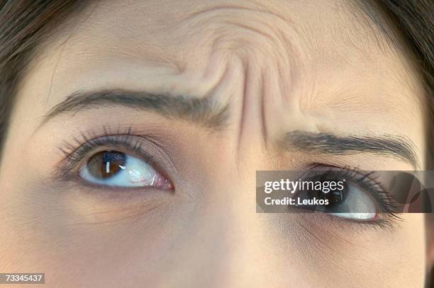 woman with wrinkled brow, high section, close-up of eyes - high forehead stock pictures, royalty-free photos & images