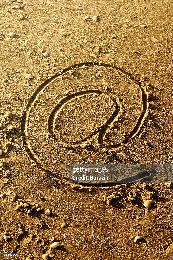 @ symbol written in sand, high angle view