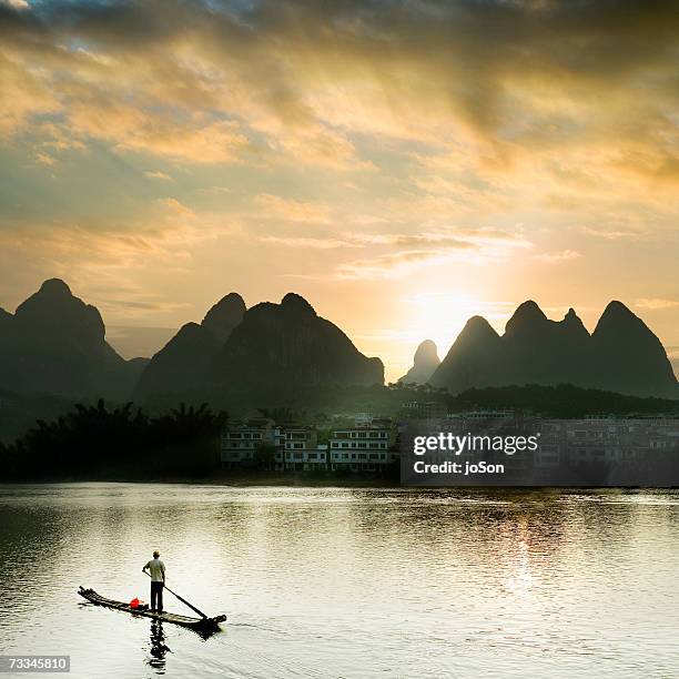 china, guangxi, yangshuo, li river at sunset, fisherman on river, elevated view - yangshuo imagens e fotografias de stock