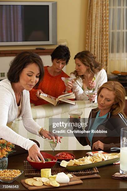 four women with cocktails and appetizers in room - reunión de chicas fotografías e imágenes de stock