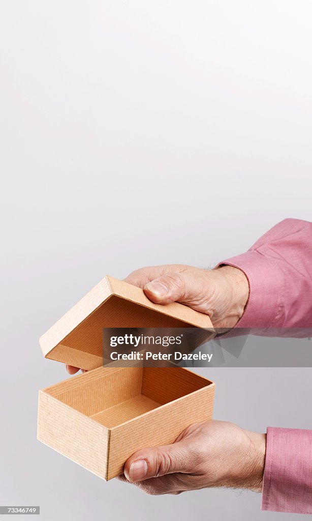 Person opening empty box