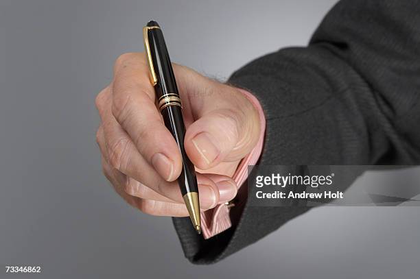 businessman holding pen, close-up - holding pen in hand stock pictures, royalty-free photos & images