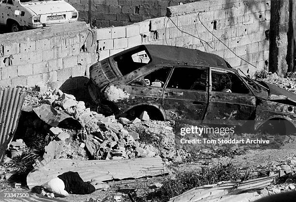 Young Palestinian woman lies wounded on the Path of Death out of the Bourj Al Barajneh refugee camp after being shot in the head and abdomen by Amal...