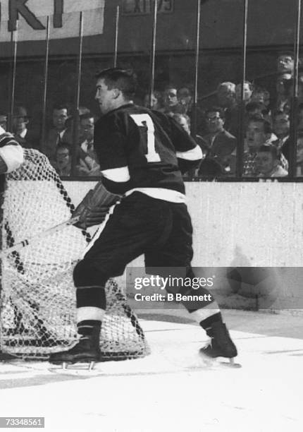 Profile view of Canadian hockey player Ted Lindsay of the Detroit Red Wings as he skates at the side of the New York Rangers net during a game, New...