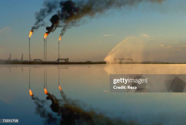 Fires burn from the tops of tall stacks at the Tengiz oil field, on the northeastern shore of the Caspian Sea on September, 1997 in Tengiz,...