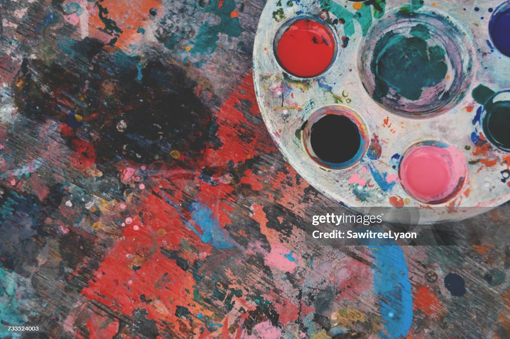 High Angle View Of Colorful Palette On Stained Wooden Table