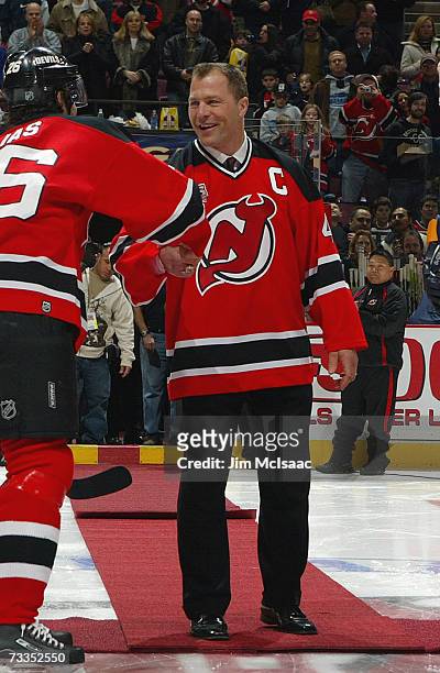 Fomer defenseman Scott Stevens of the New Jersey Devils shakes hands with Patrik Elias prior to the game against the Buffalo Sabres during their game...